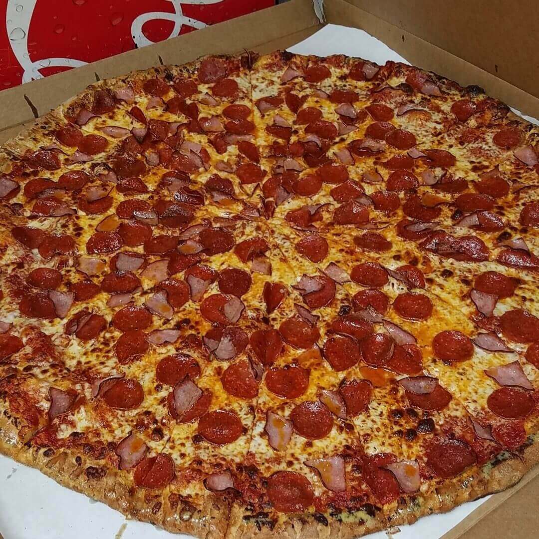 Large pepperoni pizza with crispy crust.