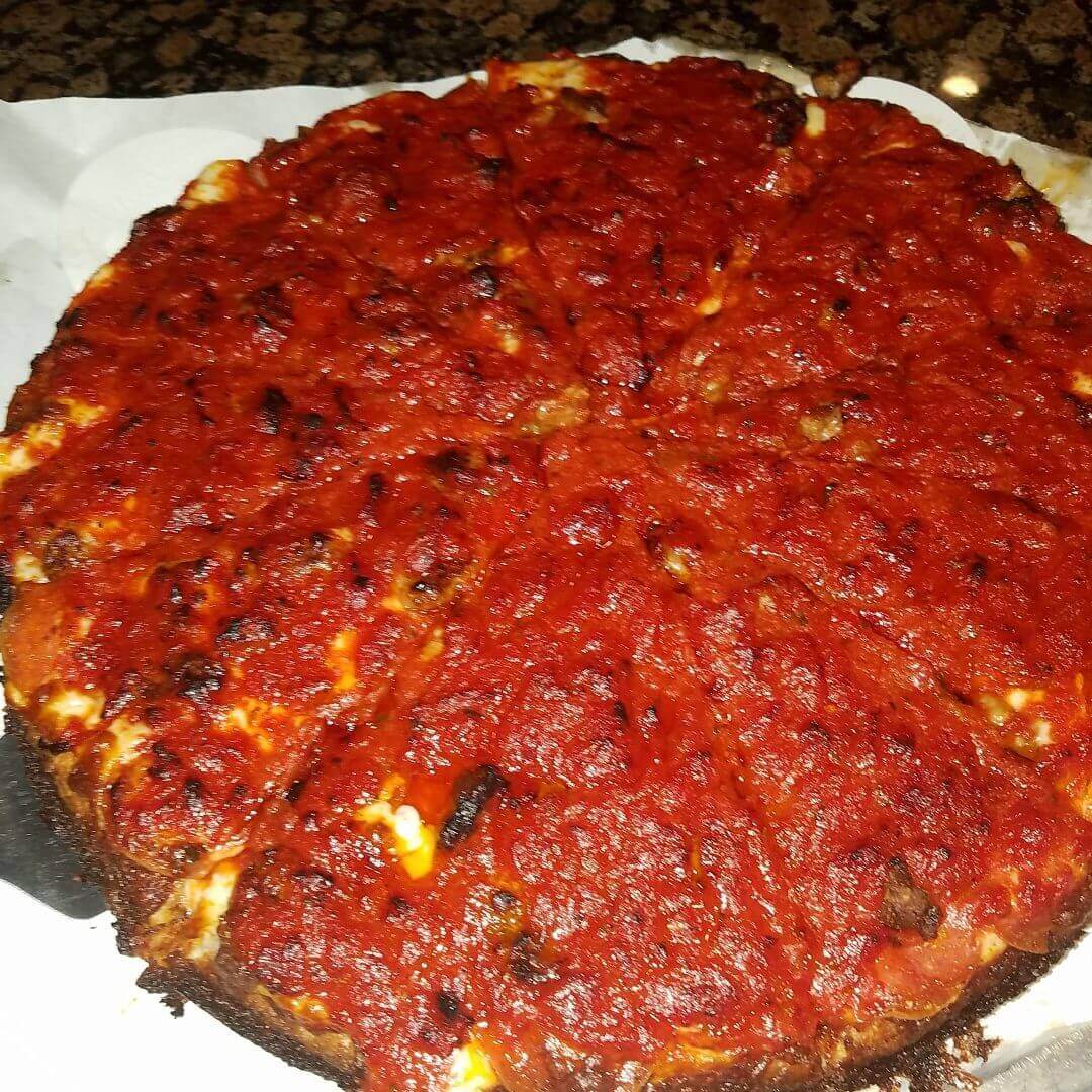 Chicago-style deep-dish pizza topped with chunky tomato sauce.